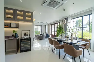 Luxurious open-plan living and dining area with modern decor and large windows