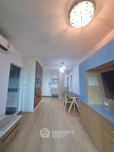 Spacious modern living room with wooden flooring and stylish furniture