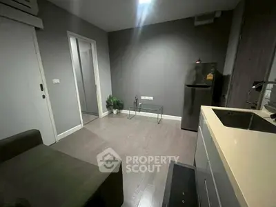 Modern compact living space with sleek kitchen and cozy seating area, perfect for urban living.