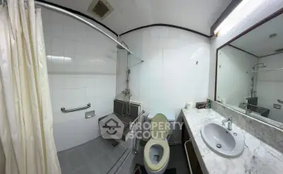 Spacious bathroom with modern fixtures and marble countertop in a contemporary home.