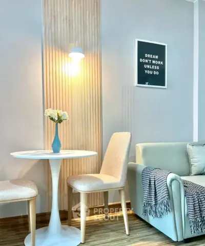 Chic living room with modern decor, cozy seating, and motivational wall art.