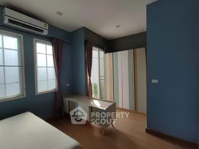 Spacious bedroom with modern decor and ample natural light