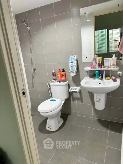 Modern bathroom with sleek fixtures and ample storage in a contemporary apartment.