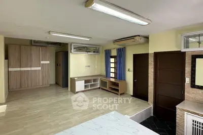 Spacious modern living room with wooden flooring and ample natural light