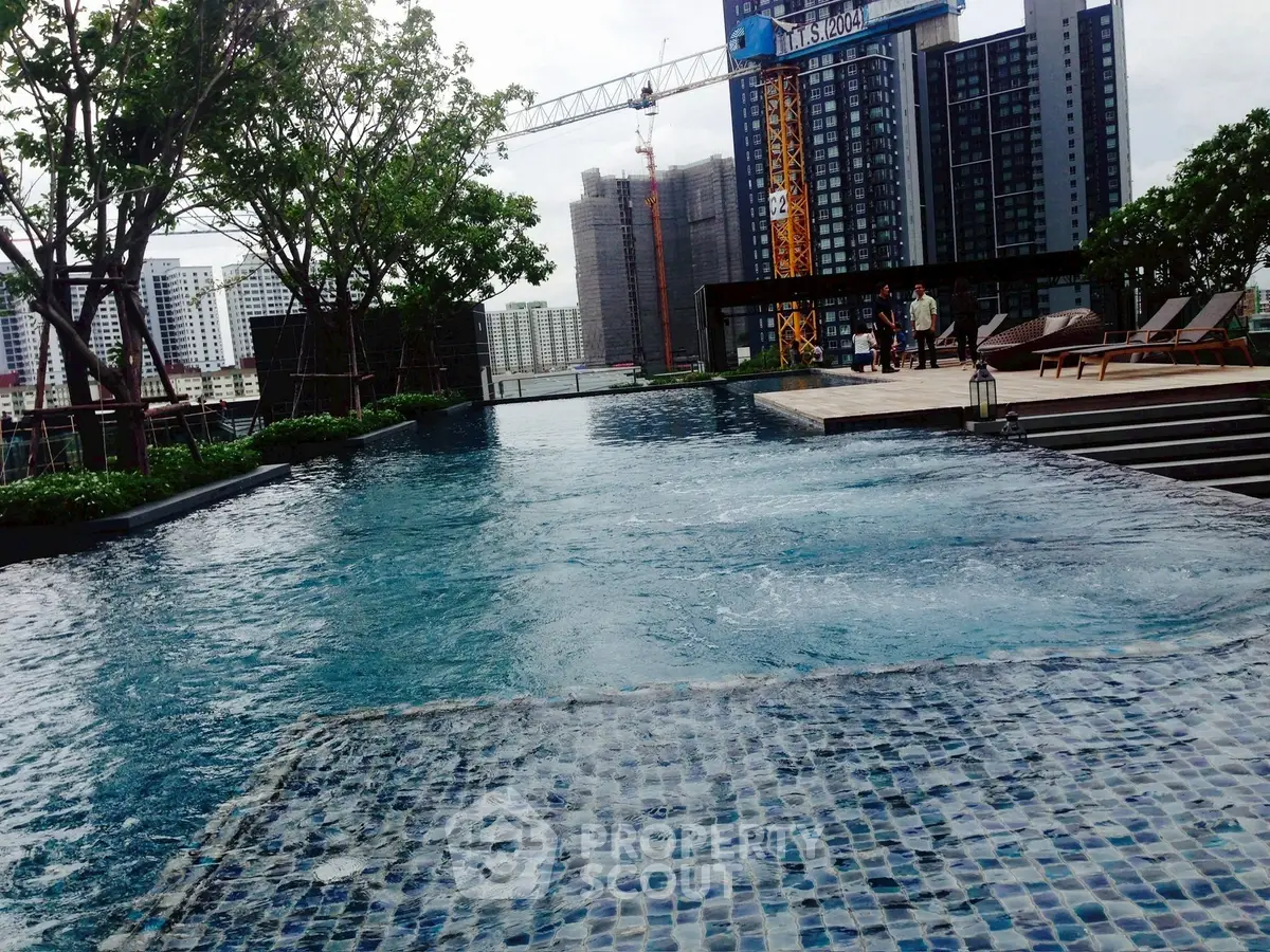 Luxurious rooftop pool with city skyline view and modern amenities.