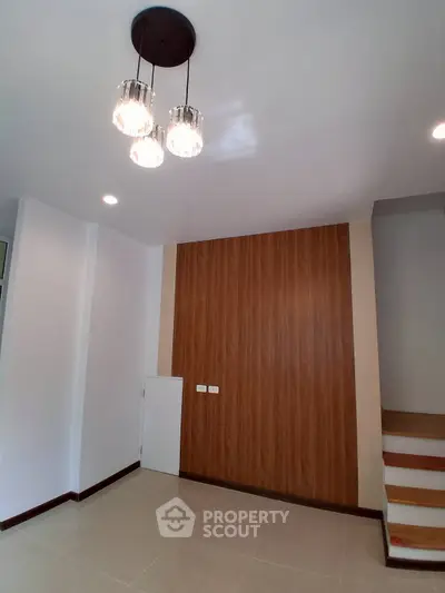 Modern interior with elegant lighting and wooden accent wall in a stylish home