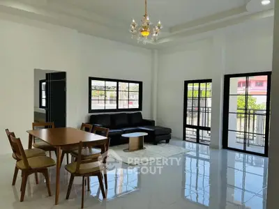 Spacious living room with modern furniture and large windows for natural light.