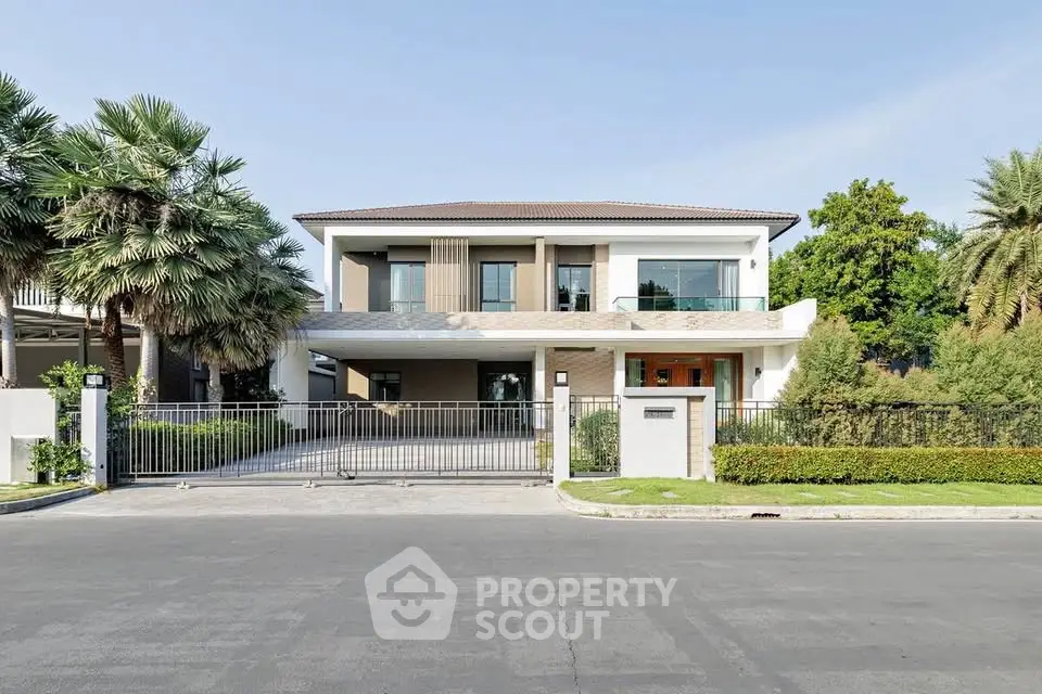 Luxurious modern house with spacious driveway and lush greenery in a serene neighborhood.