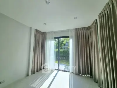 Bright empty room with large window and elegant curtains, perfect for customization.