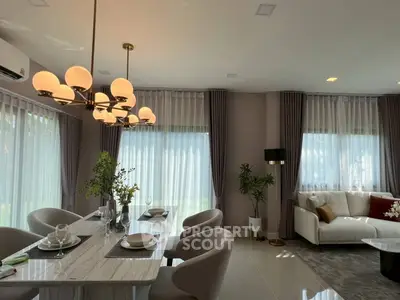 Elegant living room with modern dining area and stylish lighting, perfect for entertaining guests.