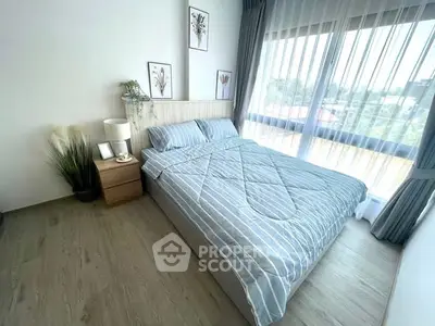 Bright and cozy bedroom with large window and stylish decor