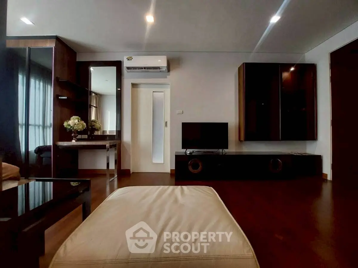 Spacious modern living room with sleek furniture and ambient lighting