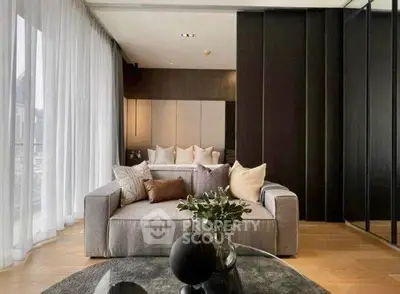 Luxurious modern living room with elegant decor and floor-to-ceiling windows.