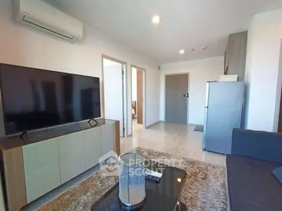 Modern living room with sleek TV, air conditioning, and cozy decor