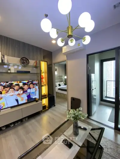 Modern living room with stylish chandelier and balcony view