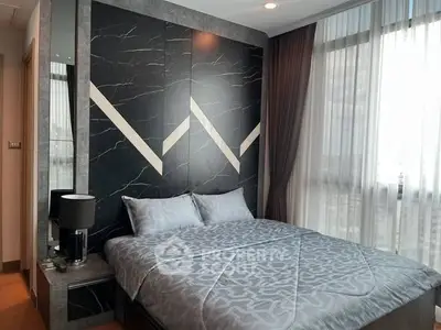 Modern bedroom with stylish decor and large window for natural light