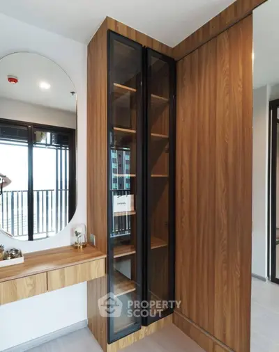 Modern bedroom with stylish wooden wardrobe and elegant mirror