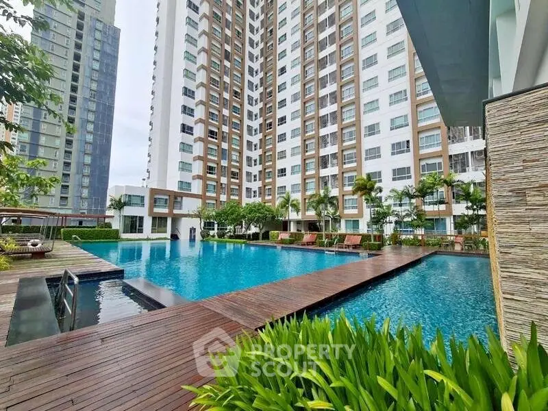 Luxurious high-rise apartment with stunning pool and lush greenery