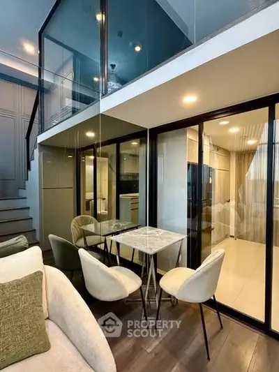 Modern duplex apartment with glass walls and stylish furniture