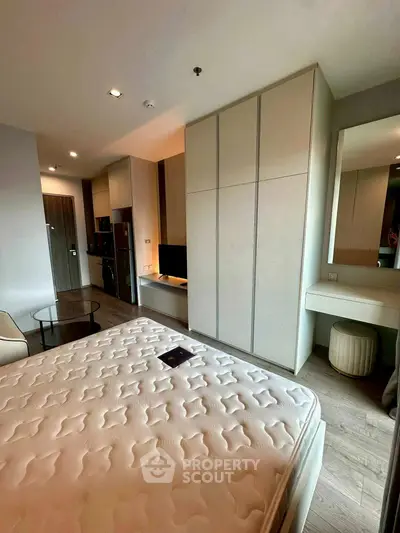 Modern bedroom with built-in wardrobe and cozy lighting in a stylish apartment.