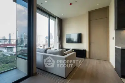 Modern living room with floor-to-ceiling windows and stunning city view.