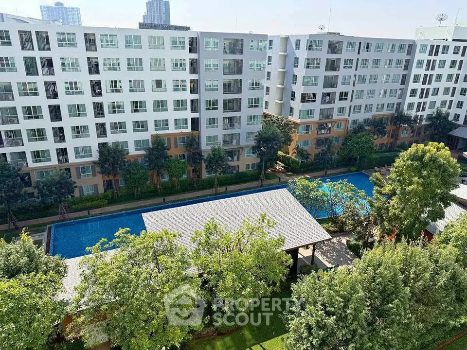 Modern apartment complex with pool and lush greenery, ideal for urban living.