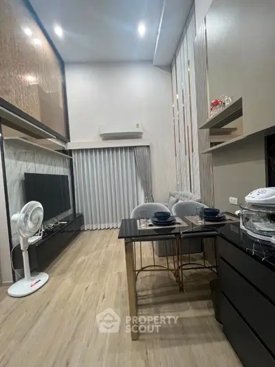 Modern living room with sleek design, featuring dining area and air conditioning, perfect for urban living.