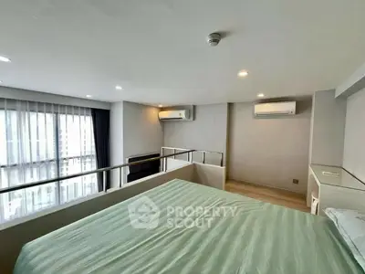 Modern bedroom with large window and air conditioning in a stylish apartment.