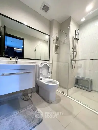 Modern bathroom with sleek fixtures and spacious shower area