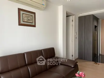Modern living room with brown leather sofa and air conditioning in a stylish apartment.
