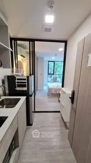 Modern compact kitchen with sleek design and open view to bedroom