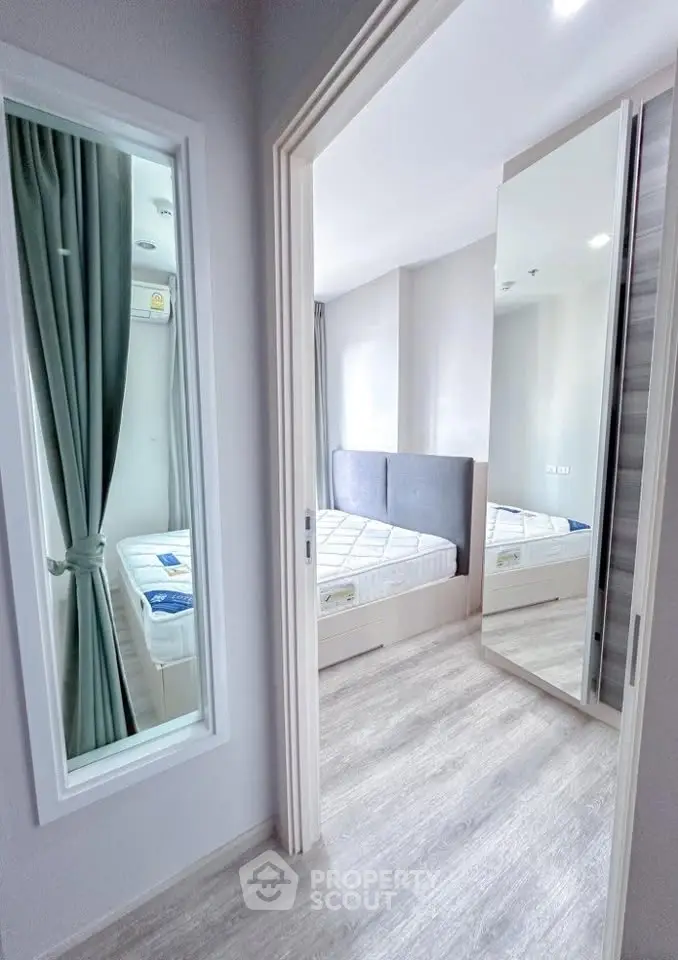 Modern bedroom with mirrored closet and natural light in stylish apartment