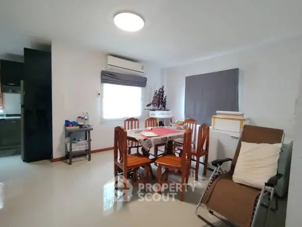 Cozy dining area with wooden furniture and modern decor in a bright apartment.