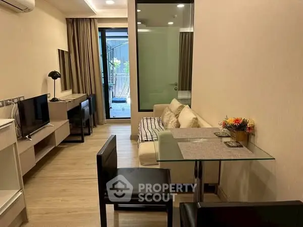 Modern living room with stylish decor and glass dining table, perfect for urban living.