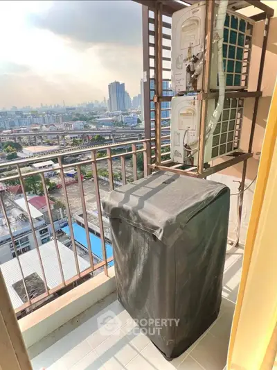 High-rise balcony with city view and air conditioning unit, perfect for urban living.