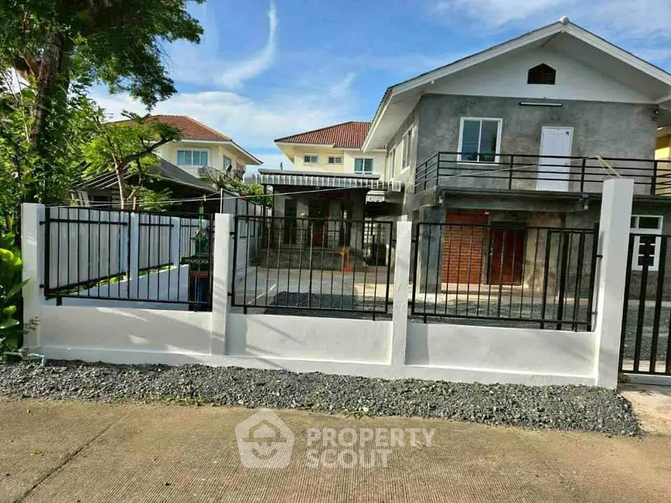 Charming suburban home with modern exterior and spacious front yard, perfect for family living.