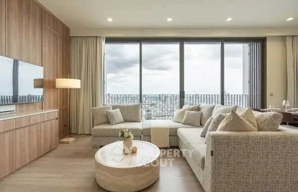 Luxurious living room with panoramic city view and elegant furnishings.