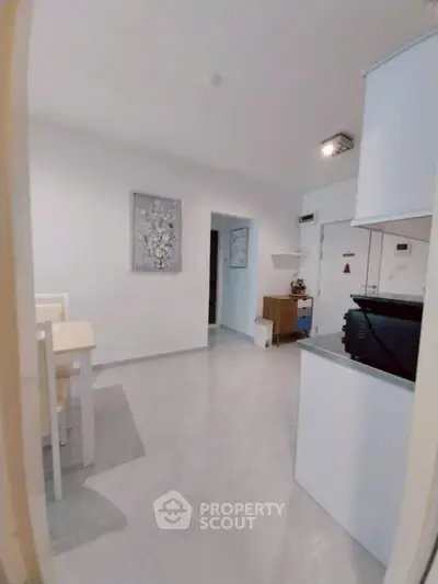 Modern open layout with sleek kitchen and dining area, perfect for contemporary living.