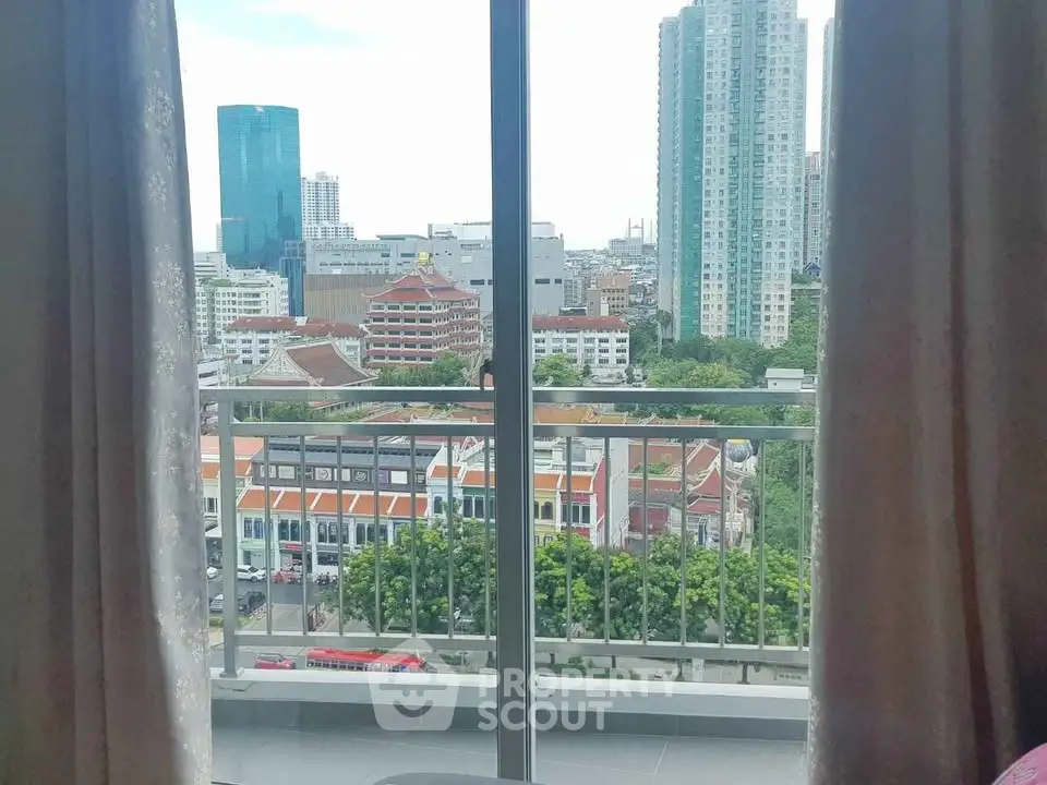 Stunning city view from a high-rise balcony with modern urban skyline.