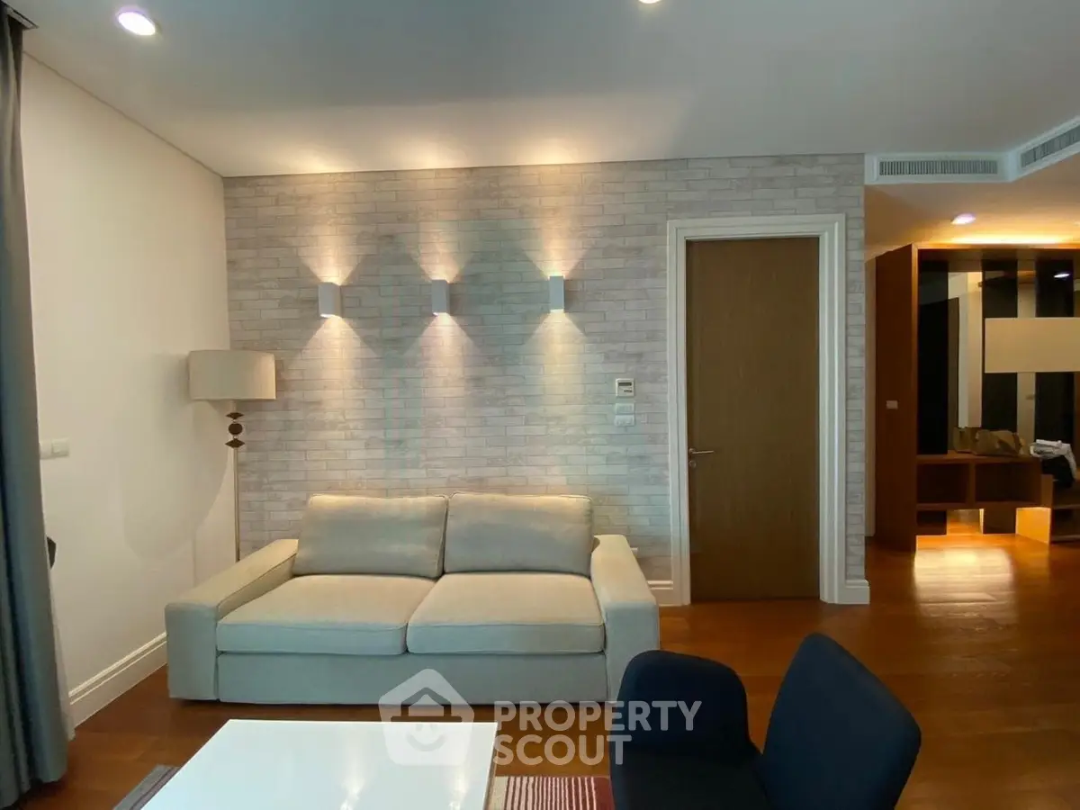 Modern living room with stylish lighting and cozy seating area in a contemporary apartment.