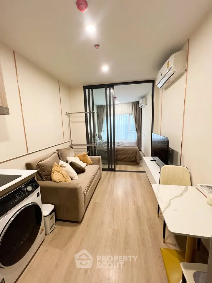 Modern studio apartment with cozy living area and bedroom, featuring stylish decor and efficient layout.