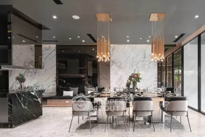 Luxurious modern dining room with elegant marble accents and stylish lighting fixtures.