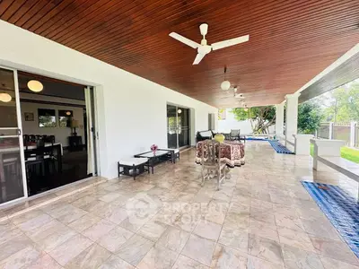 Spacious covered patio with stylish ceiling fans and elegant outdoor seating.