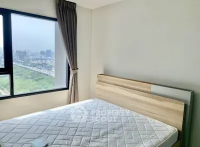 Modern bedroom with large window offering stunning city view