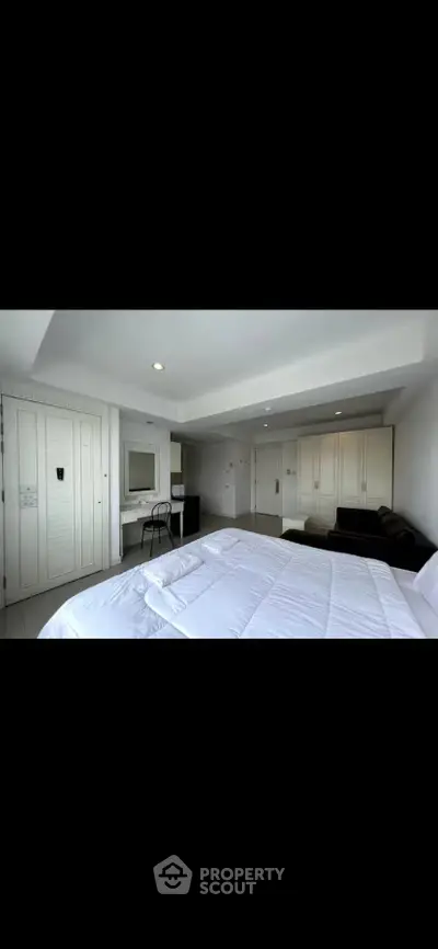 Spacious modern bedroom with sleek design and ample storage space