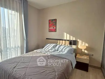 Cozy bedroom with natural light and modern decor, perfect for relaxation.