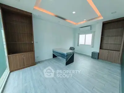 Spacious modern study room with built-in shelves and large window