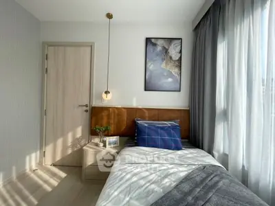 Cozy bedroom with modern decor and ample natural light