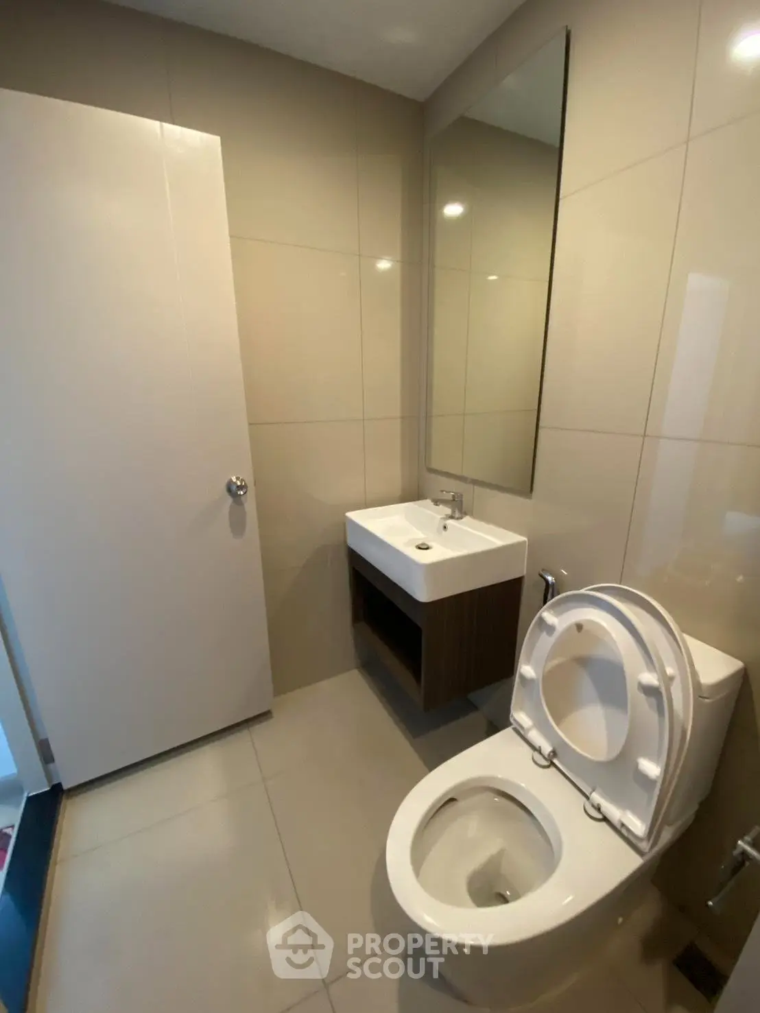 Modern bathroom with sleek fixtures and neutral tiles, perfect for a contemporary home.