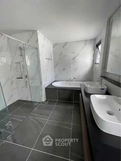 Luxurious modern bathroom with marble tiles and dual sinks